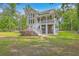 Charming home with a spacious porch, complemented by lush landscaping and a serene natural setting at 100 Canal Rd, Saint George, SC 29477