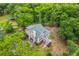 Aerial shot of a two-story home with verdant surroundings, driveway, and inviting front porch at 100 Canal Rd, Saint George, SC 29477
