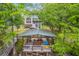 Aerial view showcases the house and outdoor entertainment area by the lake at 100 Canal Rd, Saint George, SC 29477