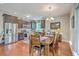 Open kitchen and dining area with stainless steel appliances and wood floors at 100 Canal Rd, Saint George, SC 29477