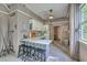 A simple kitchenette with cabinets, an island, and seating in an entertainment space at 100 Canal Rd, Saint George, SC 29477