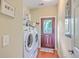 Laundry room features a washer, dryer, exterior door and storage at 100 Canal Rd, Saint George, SC 29477