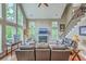 Bright living area with a fireplace, a staircase, and large windows at 100 Canal Rd, Saint George, SC 29477