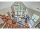 Open-concept living room with soaring ceilings, large windows, and a cozy fireplace at 100 Canal Rd, Saint George, SC 29477