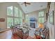 Vaulted living room with a fireplace and lots of natural light from large windows at 100 Canal Rd, Saint George, SC 29477