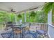 Charming porch with comfortable seating, ceiling fan, and views of the surrounding greenery at 100 Canal Rd, Saint George, SC 29477