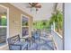 Comfortable porch with ceiling fan, wood floors and comfortable seating at 100 Canal Rd, Saint George, SC 29477