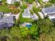 Aerial view of a home with an in-ground pool, complemented by lush greenery and well-maintained landscaping at 11 Dalton St, Daniel Island, SC 29492