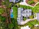 Aerial view of a home with a pool and outdoor dining area surrounded by manicured landscaping at 11 Dalton St, Daniel Island, SC 29492