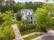 Beautiful two-story home with double porches, mature trees, and lush landscaping at 11 Dalton St, Daniel Island, SC 29492