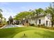 Gorgeous backyard with pool, putting green, and manicured lawn offers the ultimate outdoor oasis at 11 Dalton St, Daniel Island, SC 29492