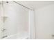 A clean bathroom features white tiling, a shower-tub combo, and chrome hardware at 11 Dalton St, Daniel Island, SC 29492
