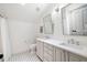 Bathroom features a double vanity, black and white floor tiles, and a shower-tub combo at 11 Dalton St, Daniel Island, SC 29492