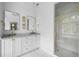 Bright bathroom with marble shower, double sink vanity, and classic gold fixtures at 11 Dalton St, Daniel Island, SC 29492