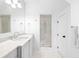 Bright bathroom featuring white cabinetry, marble countertops, and a glass-enclosed shower at 11 Dalton St, Daniel Island, SC 29492