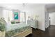 Bright bedroom features two windows, white curtains, and a serene art piece above a chair at 11 Dalton St, Daniel Island, SC 29492