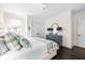 This bedroom has a decorative dresser with a mirror and a bed with a patterned coverlet at 11 Dalton St, Daniel Island, SC 29492