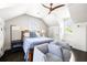 Cozy bedroom with a patterned quilt, two chairs, and a dark wood ceiling fan at 11 Dalton St, Daniel Island, SC 29492