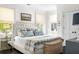 The primary bedroom offers lots of natural light, refined decor, and dark wood flooring at 11 Dalton St, Daniel Island, SC 29492