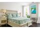 Comfortable bedroom with queen bed, natural light, and heron painting at 11 Dalton St, Daniel Island, SC 29492
