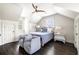 Bright bedroom with two chairs, a patterned quilt, and a dark wood ceiling fan at 11 Dalton St, Daniel Island, SC 29492
