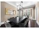 Bright dining room with natural light illuminating the modern chandelier and large dining table at 11 Dalton St, Daniel Island, SC 29492