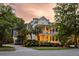 Attractive two-story home features double porches, mature trees, and a well-manicured lawn at 11 Dalton St, Daniel Island, SC 29492
