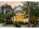 Charming two-story home boasting double porches and lush landscaping with palm trees at 11 Dalton St, Daniel Island, SC 29492