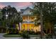 Charming two-story home featuring double porches, wreaths on doors, and landscape lighting at 11 Dalton St, Daniel Island, SC 29492