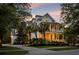 Attractive two-story home features double porches, mature trees, and a well-manicured lawn at 11 Dalton St, Daniel Island, SC 29492