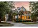Charming two-story home with double porches, palm trees, and exterior lighting at 11 Dalton St, Daniel Island, SC 29492
