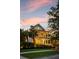 Elegant two-story home with double porches, decorative wreaths, and landscape lighting at 11 Dalton St, Daniel Island, SC 29492