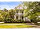 Beautiful two-story home featuring double porches and well-manicured landscaping at 11 Dalton St, Daniel Island, SC 29492