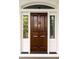 Elegant dark wood front door with a decorative seashell knocker and sidelights at 11 Dalton St, Daniel Island, SC 29492