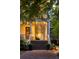 Inviting front porch with seating area, ceiling fans, and manicured landscaping at 11 Dalton St, Daniel Island, SC 29492