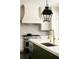 Gourmet kitchen features stainless steel appliances, a marble backsplash, and a green kitchen island with marble countertop at 11 Dalton St, Daniel Island, SC 29492