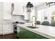 Modern kitchen featuring a green island with a marble countertop and stainless-steel appliances at 11 Dalton St, Daniel Island, SC 29492