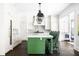 Bright and modern kitchen with green island, marble countertops, and stainless steel appliances at 11 Dalton St, Daniel Island, SC 29492