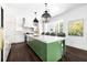 Spacious open kitchen featuring a large island with a marble countertop and wicker stools at 11 Dalton St, Daniel Island, SC 29492