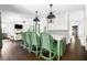 The kitchen features an island with barstool seating, pendant lights, and an adjacent living room with fireplace at 11 Dalton St, Daniel Island, SC 29492