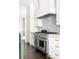 The kitchen features white cabinets, marble countertops and backsplash, and professional stainless steel appliances at 11 Dalton St, Daniel Island, SC 29492