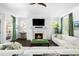 Bright and airy living room with a fireplace, white couch, and green accents at 11 Dalton St, Daniel Island, SC 29492