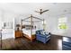Stunning main bedroom with a four-poster bed, sitting area, and en-suite bathroom entrance at 11 Dalton St, Daniel Island, SC 29492