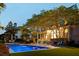 Inviting backyard pool with ample seating and charming lighting in an idyllic outdoor living space at 11 Dalton St, Daniel Island, SC 29492