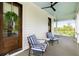 Inviting front porch with striped seating and a beautifully decorated front door, perfect for relaxing at 11 Dalton St, Daniel Island, SC 29492