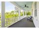 Long, covered porch with comfortable seating and ceiling fans offers a relaxing outdoor space at 11 Dalton St, Daniel Island, SC 29492