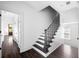 Bright staircase features dark wood floors and stairs with white risers and trim at 11 Dalton St, Daniel Island, SC 29492