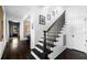 View of the foyer and stairs with dark wood treads and white risers at 11 Dalton St, Daniel Island, SC 29492
