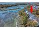 Stunning aerial view showcasing waterfront property with private dock, lush landscape, and serene waterways at 1141 Hills Plantation Dr, Charleston, SC 29412