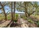 Scenic backyard with a stone pathway leading to serene water views and lush, mature trees at 1141 Hills Plantation Dr, Charleston, SC 29412